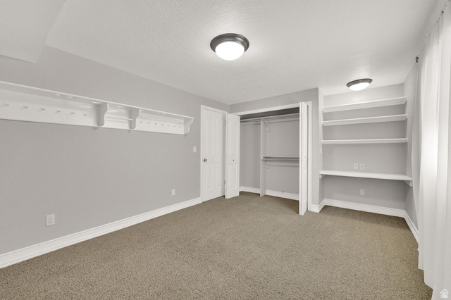 4792 Glasmann Way South Ogden, UT 84403 - Photo 64 of 70 Bedroom #6 carpeted room featuring a built-in closet with bi-fold doors, white baseboards, built-in desk with shelves and a contemporary flush-mount ceiling light and large wall shelf with ball holders and hat posts built in