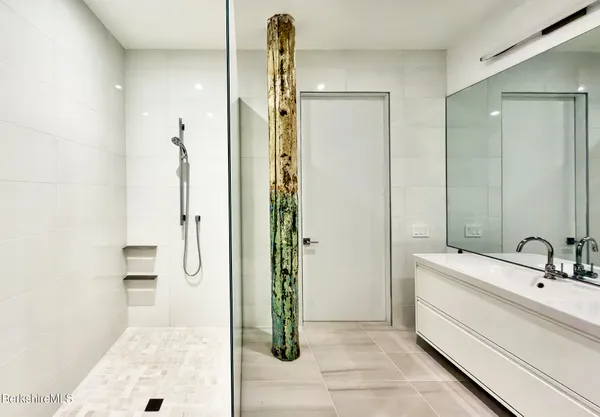 a bathroom with a double vanity sink shower and a mirror
