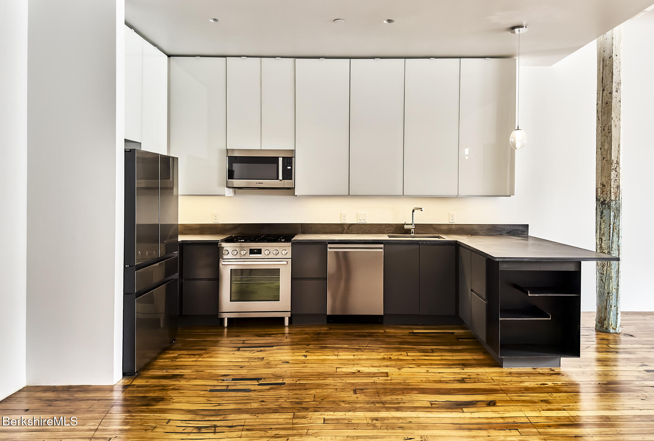 520 State Road, Unit 203 North Adams, MA 01247 - Photo 5 of 17 a kitchen with stainless steel appliances granite countertop a stove a sink and a microwave
