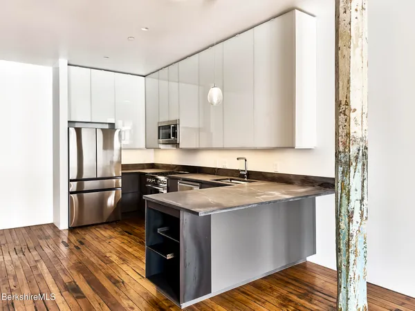 a kitchen with a stove sink and refrigerator