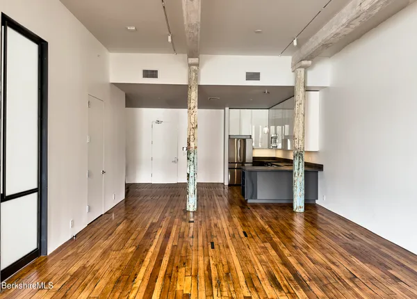 a kitchen with stainless steel appliances a refrigerator and a stove top oven