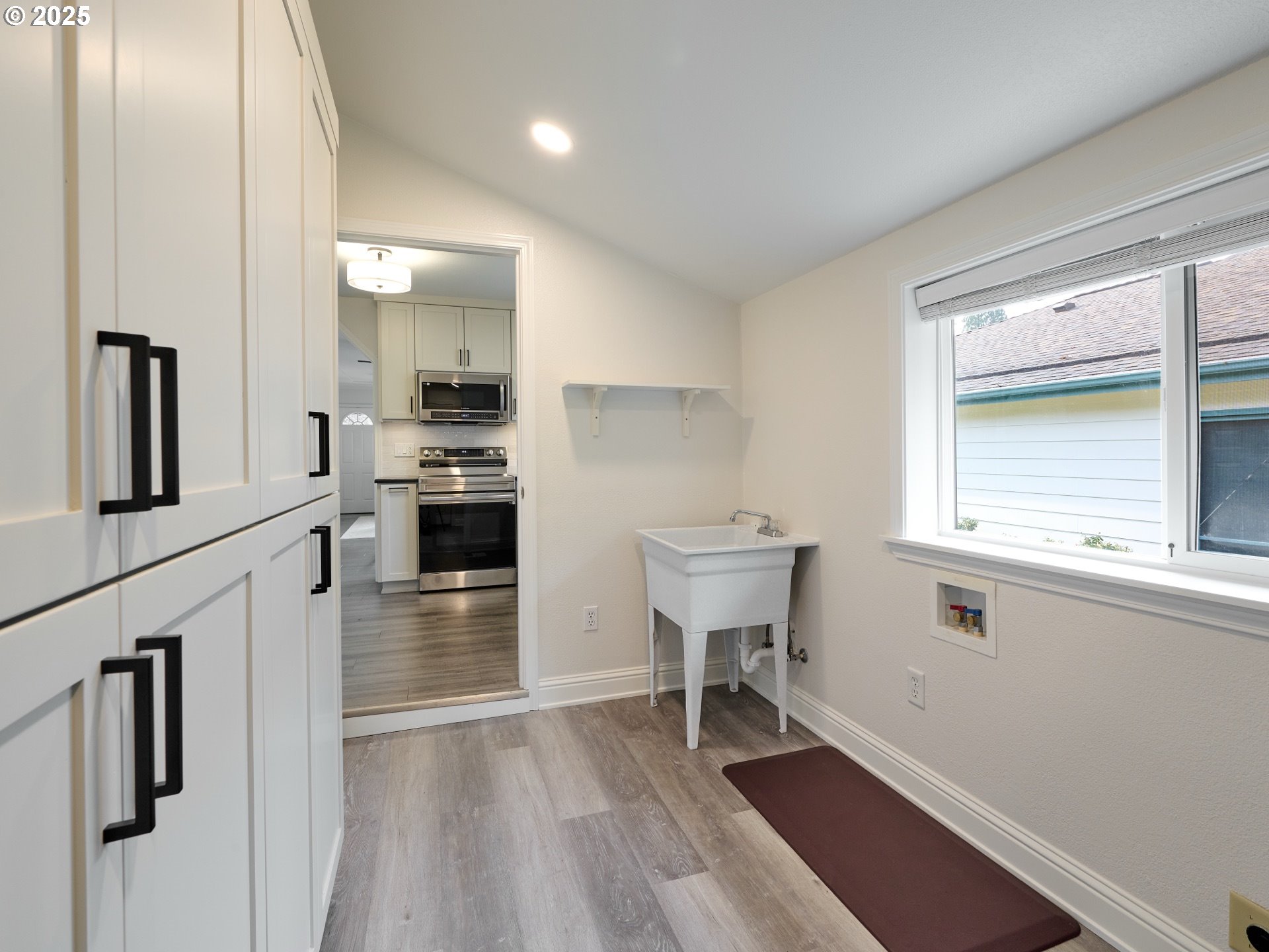 1006 Well Street Silverton, OR 97381 - Photo 22 of 35 a kitchen with cabinets and wooden floor