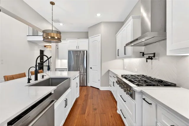 a view of a kitchen with wooden floor and a fireplace