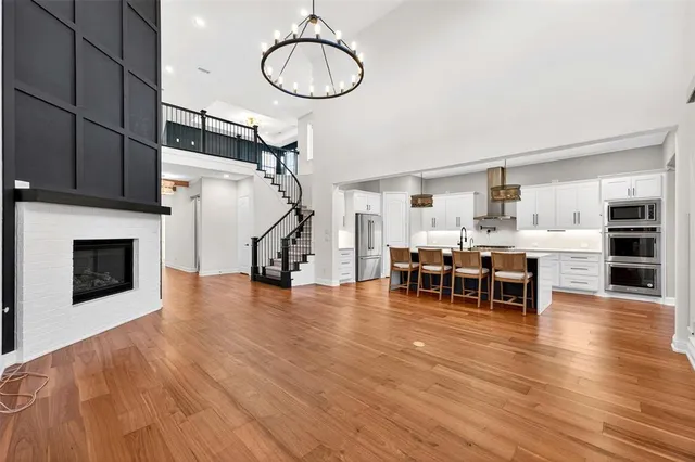 a kitchen with a sink cabinets and wooden floor
