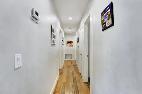 a view of a hallway view with wooden floor and staircase