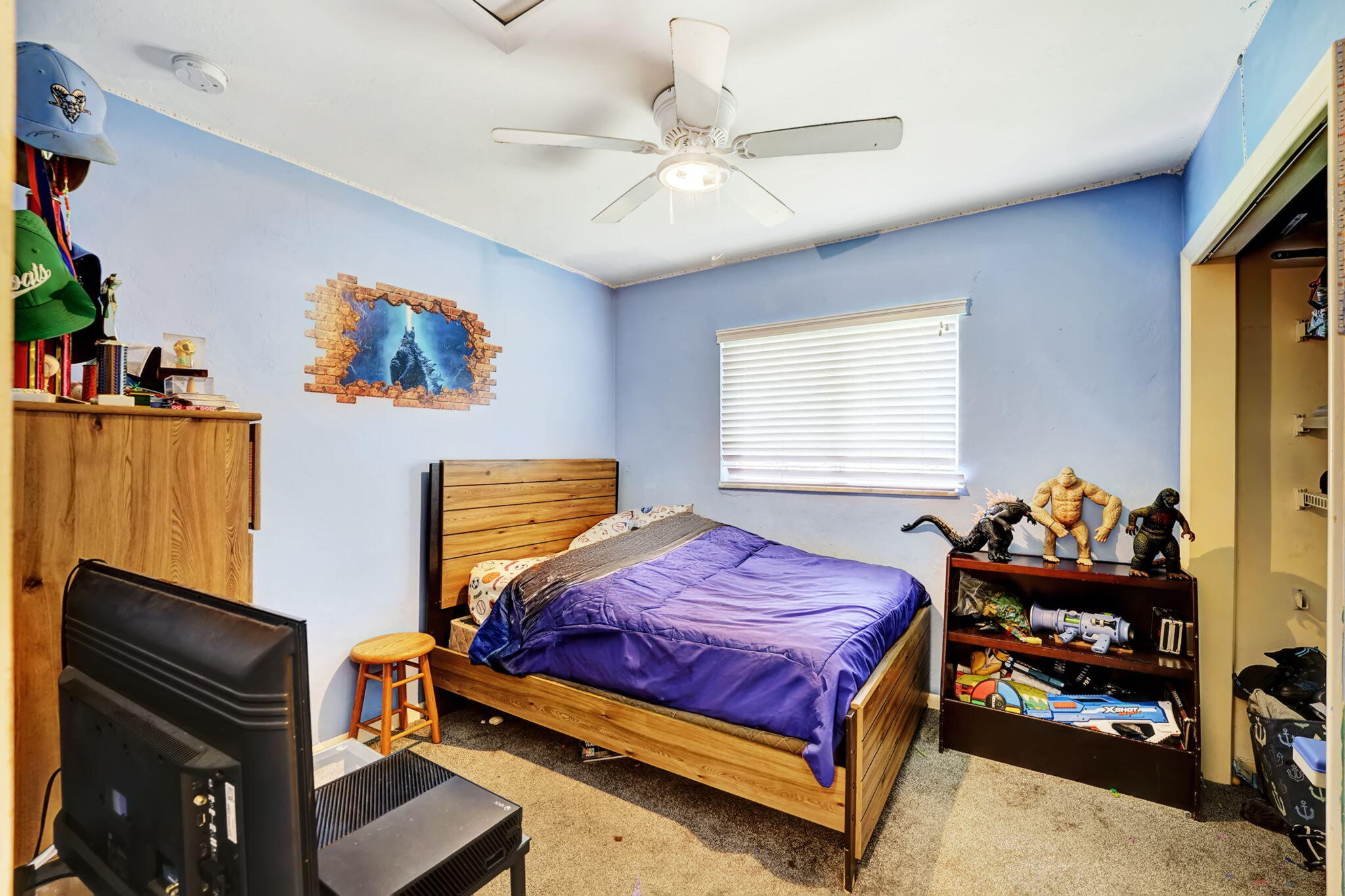 1260 Southwest 17th Street Boca Raton, FL 33486 - Photo 18 of 23 a bedroom with a bed and dresser with wooden floor