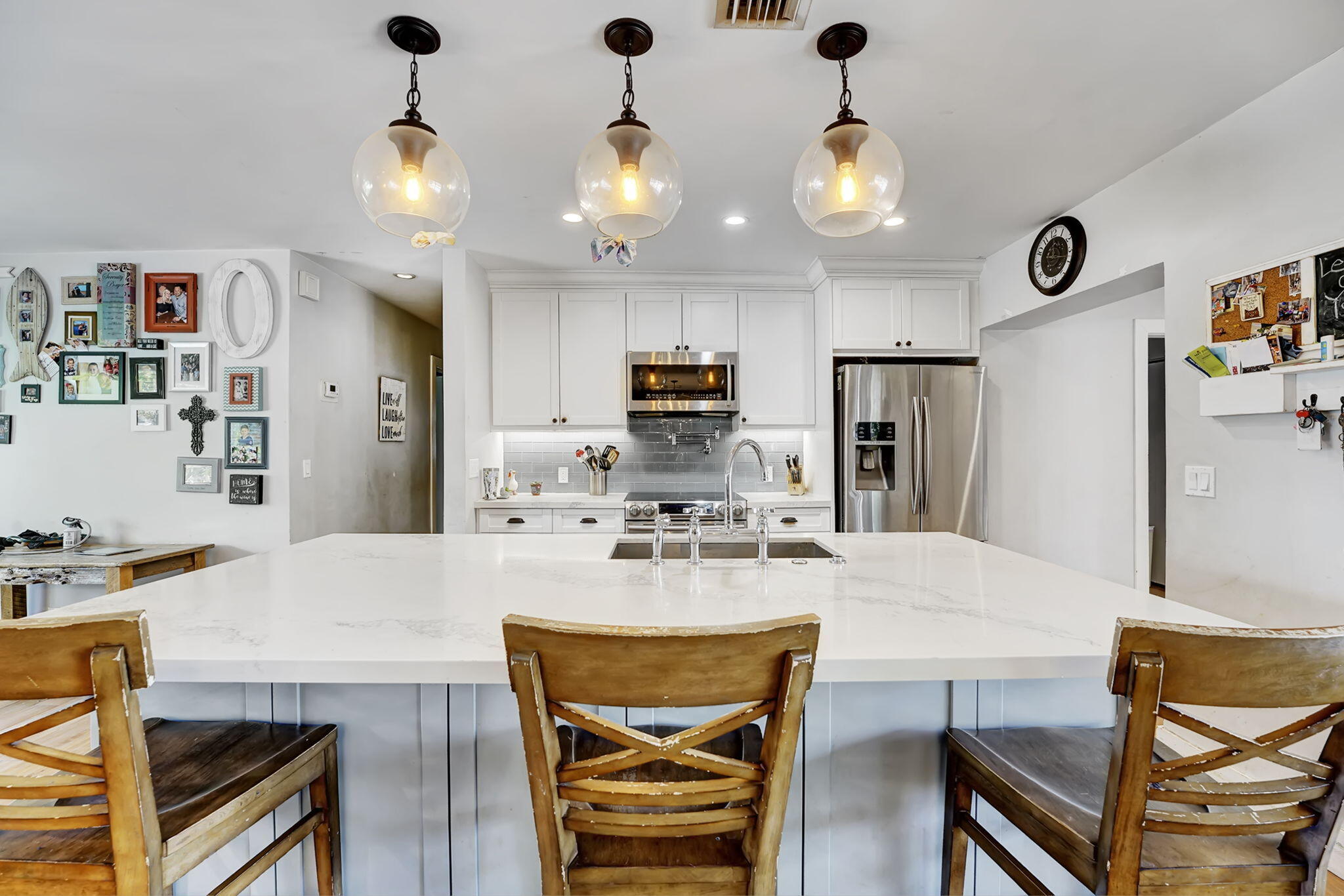 1260 Southwest 17th Street Boca Raton, FL 33486 - Photo 5 of 23 a kitchen with stainless steel appliances kitchen island granite countertop a dining table and chairs in it