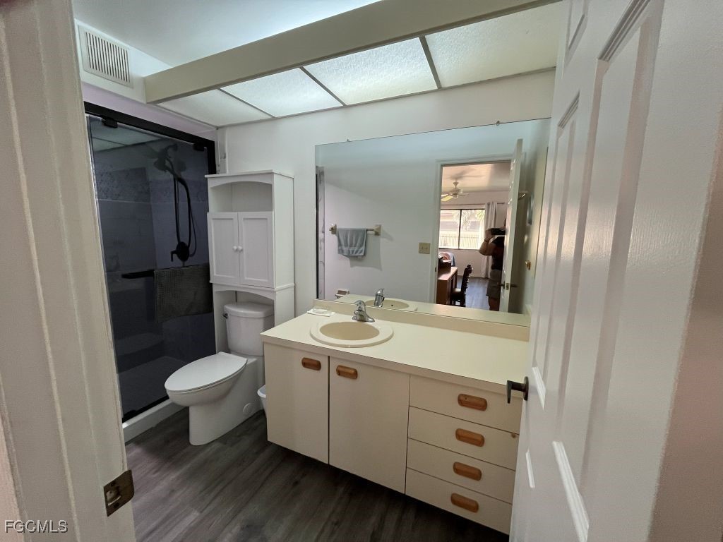 11500 Caravel Circle, Unit 4028 Fort Myers, FL 33908 - Photo 20 of 34 a bathroom with a sink toilet a mirror and shower