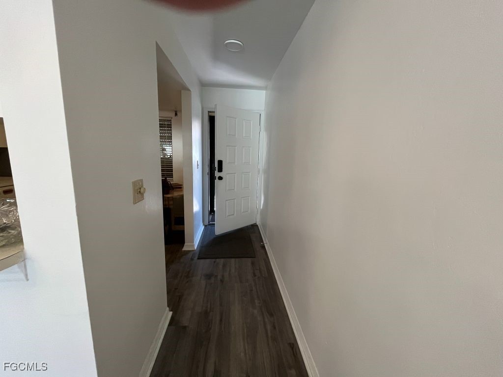 11500 Caravel Circle, Unit 4028 Fort Myers, FL 33908 - Photo 23 of 34 a view of a hallway with wooden floor