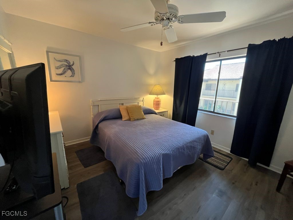 11500 Caravel Circle, Unit 4028 Fort Myers, FL 33908 - Photo 26 of 34 a bedroom with a bed dresser and a window