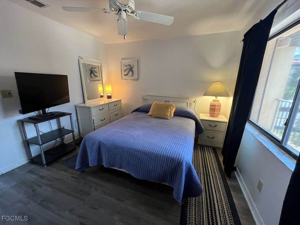 11500 Caravel Circle, Unit 4028 Fort Myers, FL 33908 - Photo 27 of 34 a bedroom with a bed and a flat tv screen on a dresser