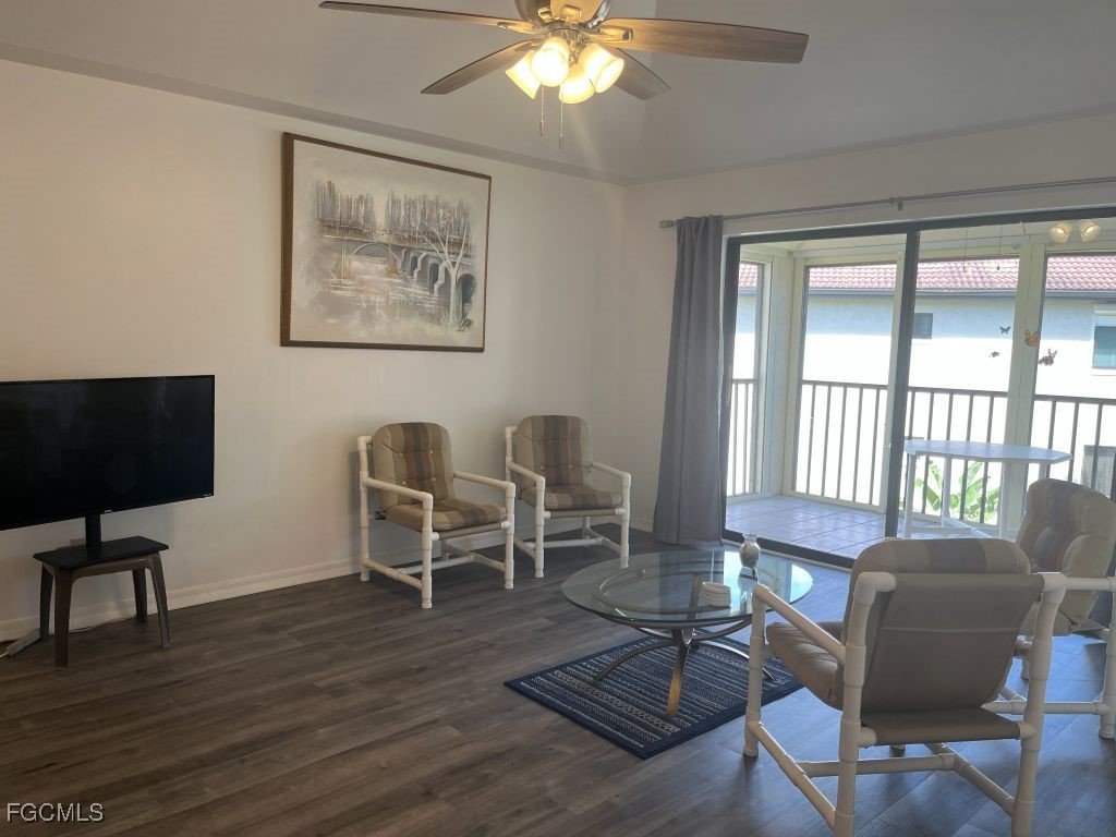 11500 Caravel Circle, Unit 4028 Fort Myers, FL 33908 - Photo 30 of 34 a living room with furniture a desk and chair with wooden floor