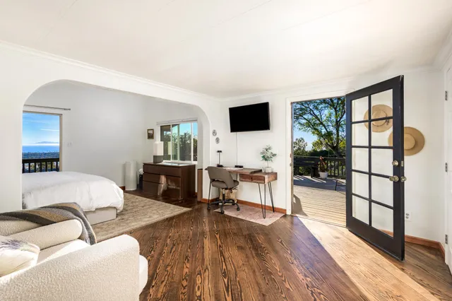 a bedroom with a large bed and a window