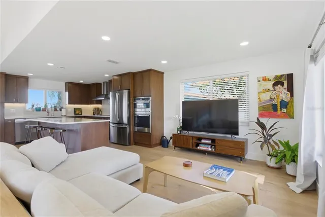 a view of a patio with dining table and chairs with wooden floor and fence