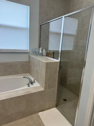 a bathroom with a bathtub and a shower