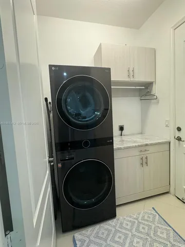 a utility room with sink dryer and washer
