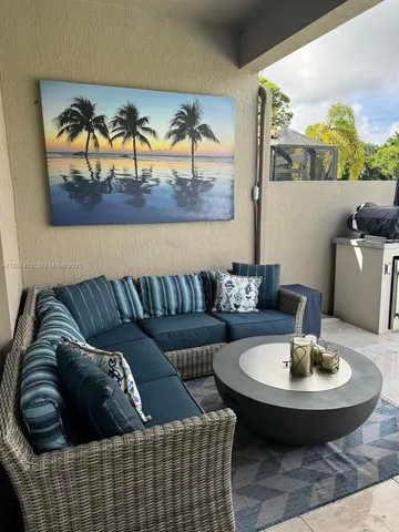 a living room with furniture and a painting on the wall