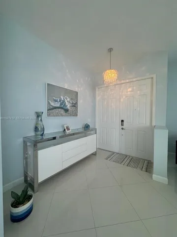 a living room with hard wood flooring and white walls