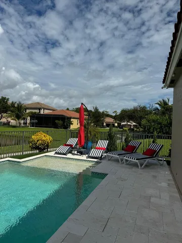 a view of a bench in backyard of the house