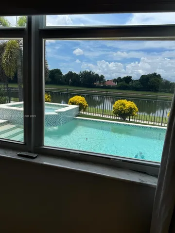 a view of swimming pool from a balcony