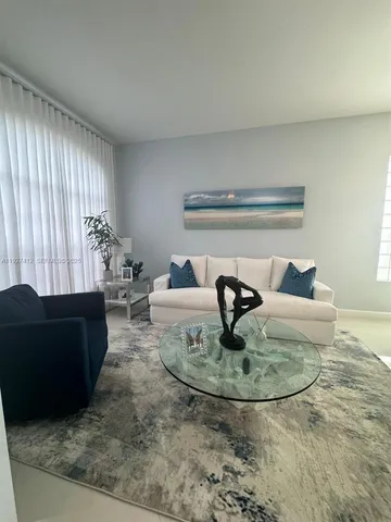 a living room with furniture and a rug