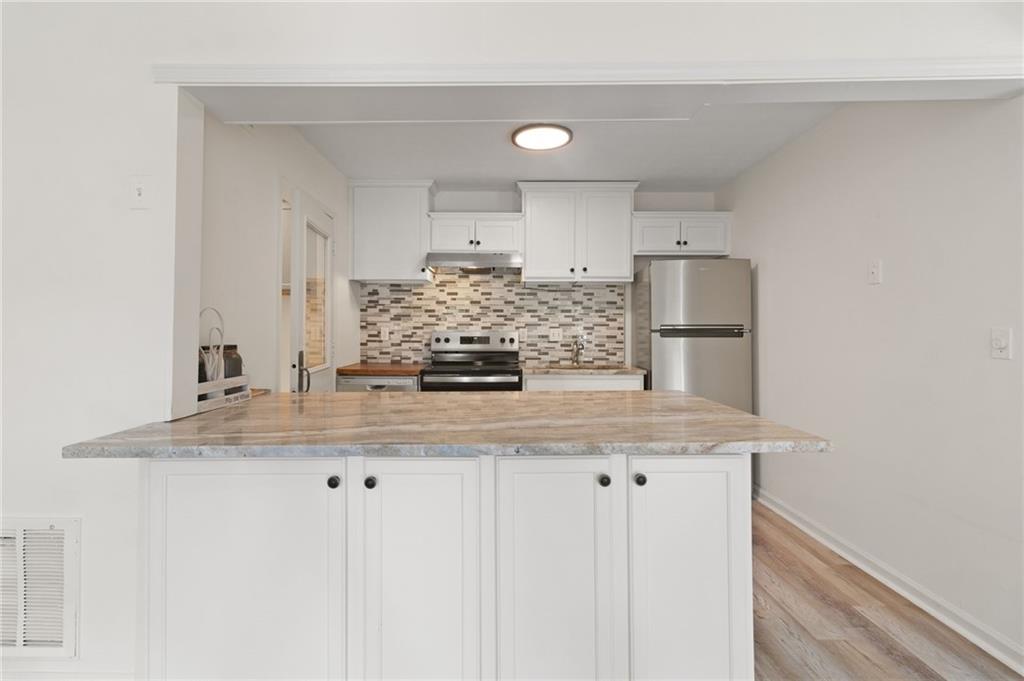 1382 Branch Drive Tucker, GA 30084 - Photo 12 of 29 a kitchen with kitchen island granite countertop a sink and cabinets