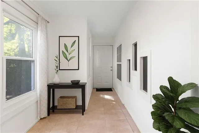 a living room with furniture and a potted plant