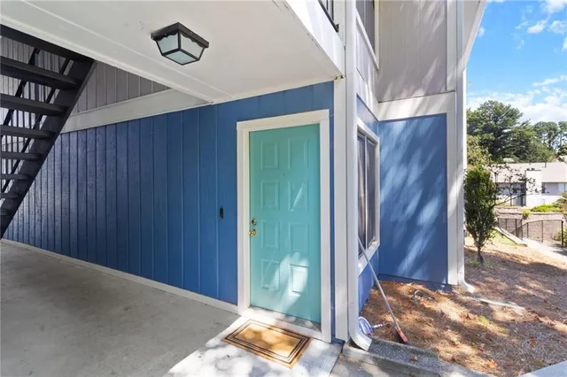 a view of a hallway with wooden floor and stairs