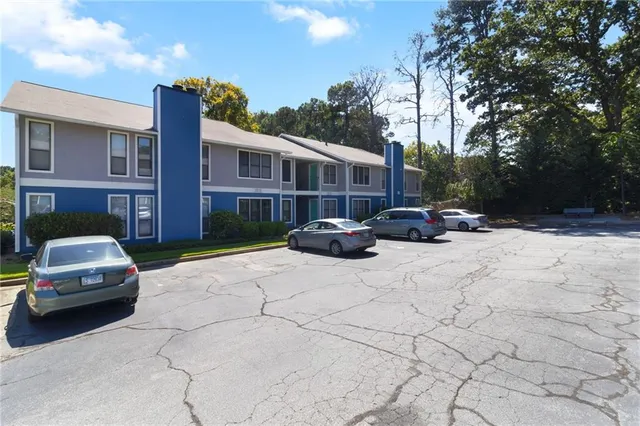 a car parked in front of a brick house