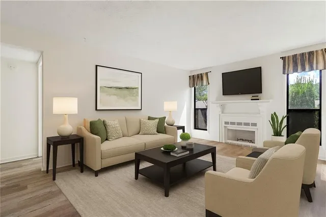 a living room with fireplace furniture and a flat screen tv