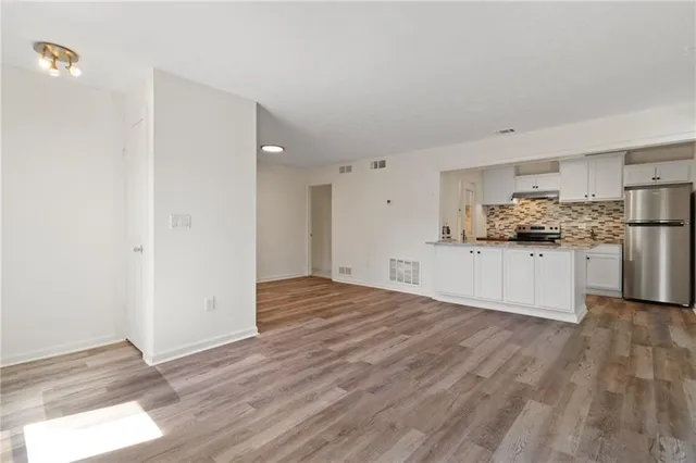 a view of a kitchen with a sink and wooden floor