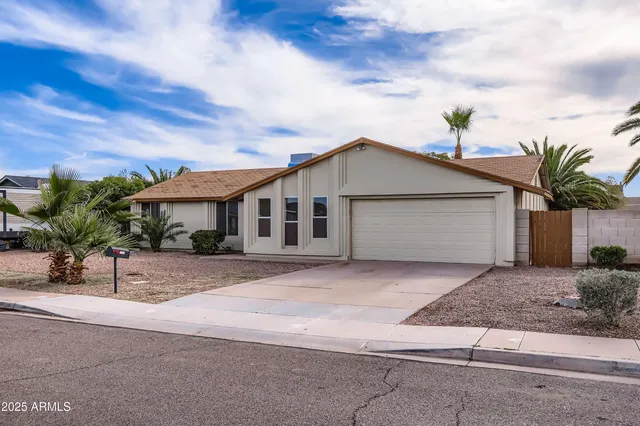 a view of a house with a yard and garage