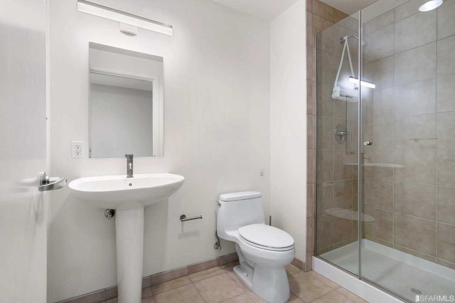 301 Main Street, Unit 17E San Francisco, CA 94105 - Photo 13 of 22 a bathroom with a sink a toilet and shower