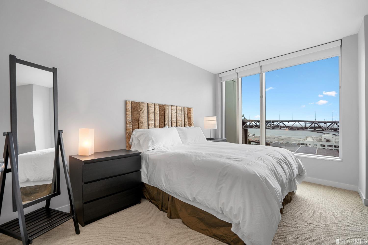 301 Main Street, Unit 17E San Francisco, CA 94105 - Photo 6 of 22 a bedroom with a bed and a large window