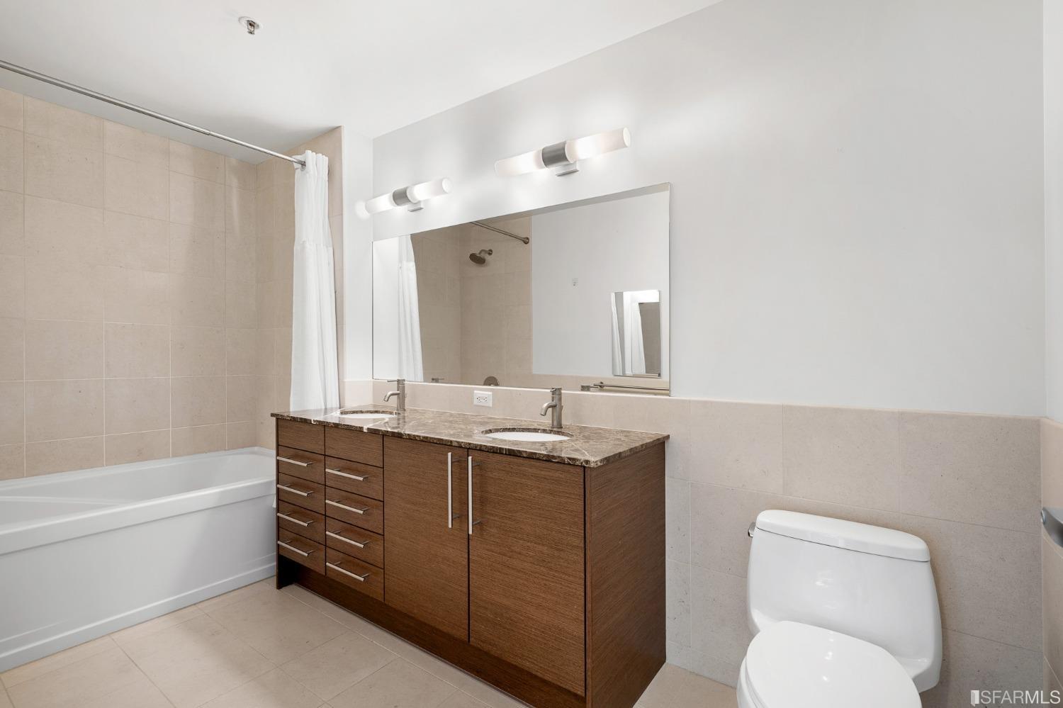 301 Main Street, Unit 17E San Francisco, CA 94105 - Photo 8 of 22 a bathroom with a granite countertop sink a toilet and a bathtub