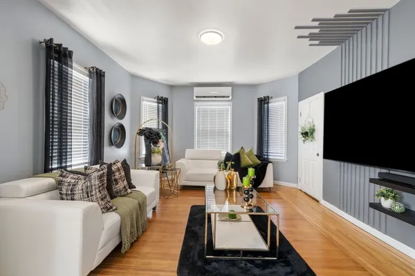a living room with furniture and a flat screen tv