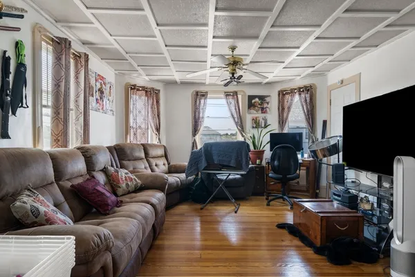 a living room with furniture and a flat screen tv