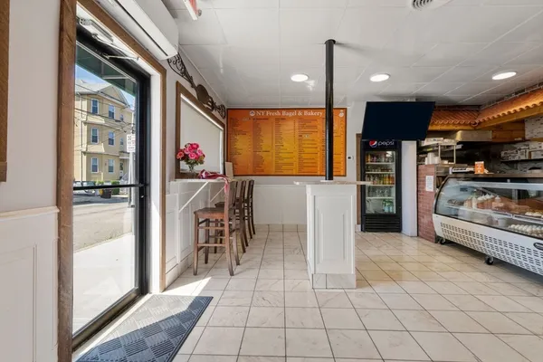 a view of a kitchen with furniture and a refrigerator