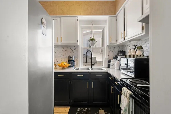 a kitchen with stainless steel appliances a sink and cabinets