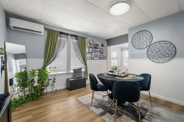 a dining room with furniture and window