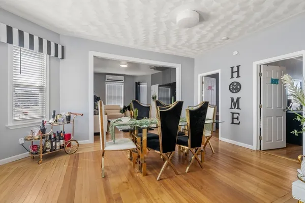 a view of a dining room with furniture and wooden floor