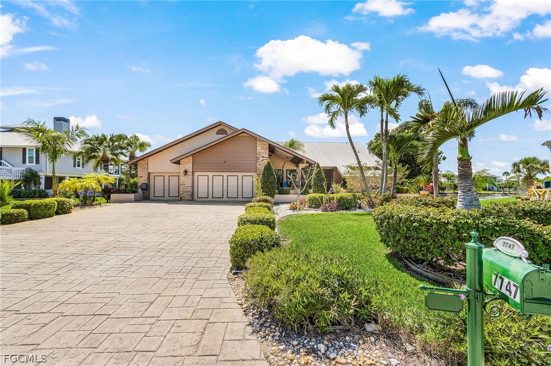 7747 Grande Pine Road Bokeelia, FL 33922 - Photo 5 of 45 a view of a garden with a house