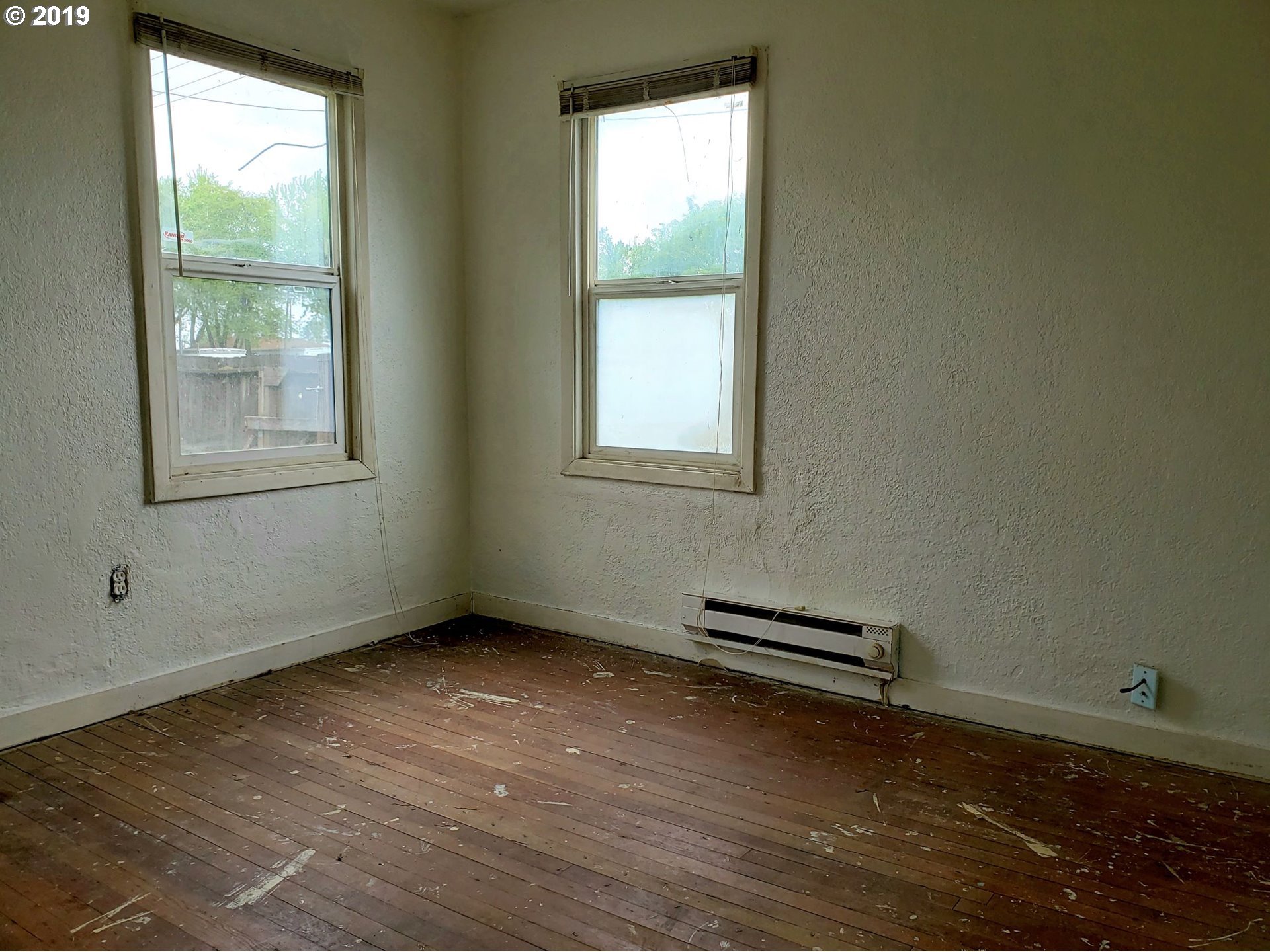 2780 E Street Springfield, OR 97477 - Photo 12 of 15 an empty room with wooden floor and windows