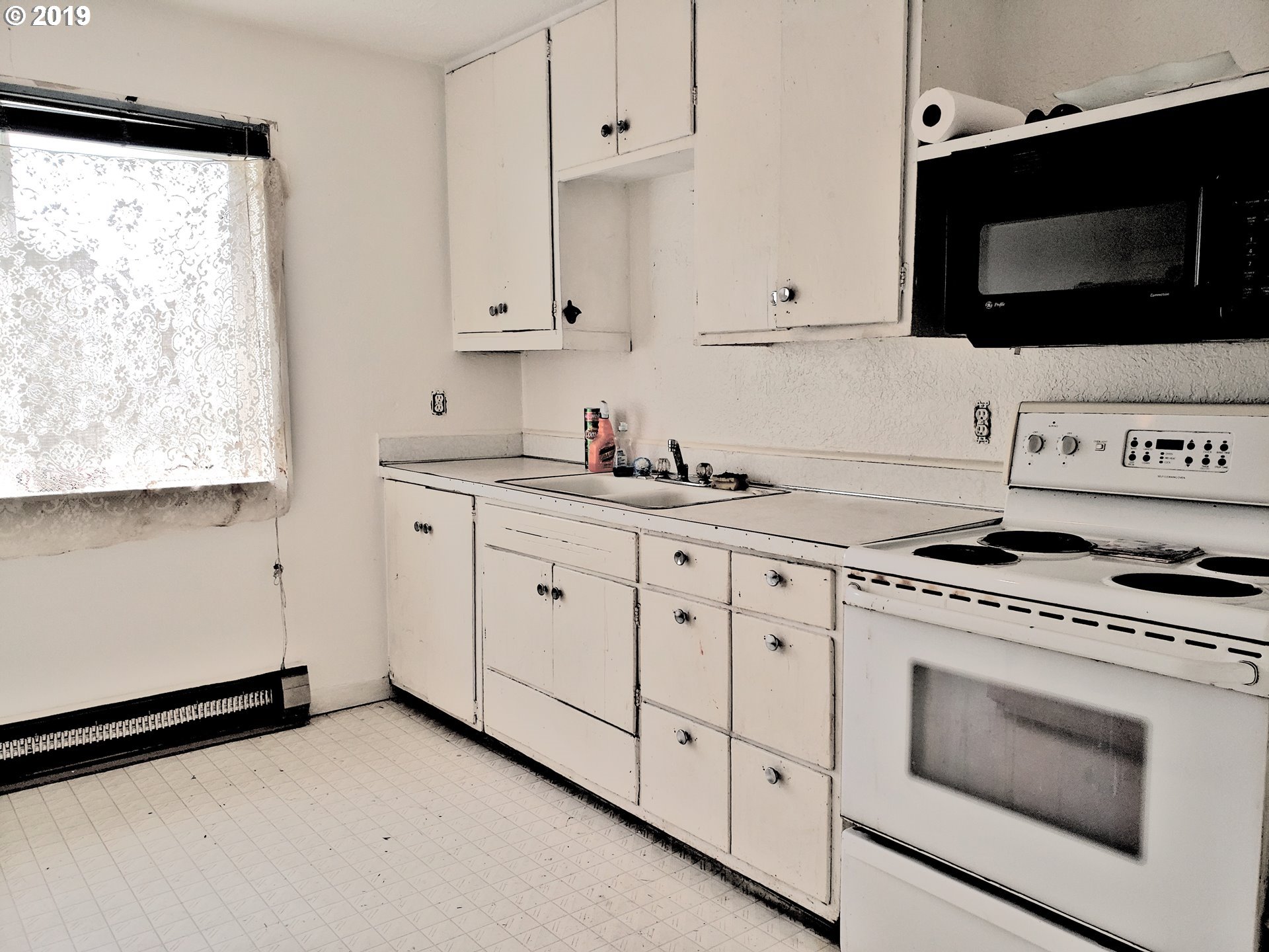 2780 E Street Springfield, OR 97477 - Photo 6 of 15 a kitchen with white cabinets stainless steel appliances and sink