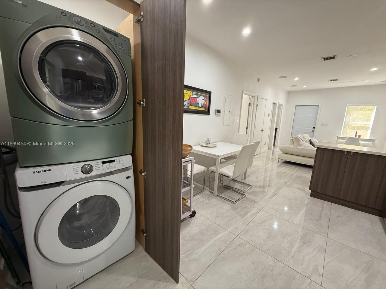 247 Northwest 58th Street Miami, FL 33127 - Photo 12 of 23 a living room with furniture and a washer dryer