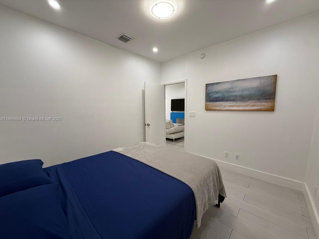 247 Northwest 58th Street Miami, FL 33127 - Photo 15 of 23 a bedroom with a bed and a view of kitchen