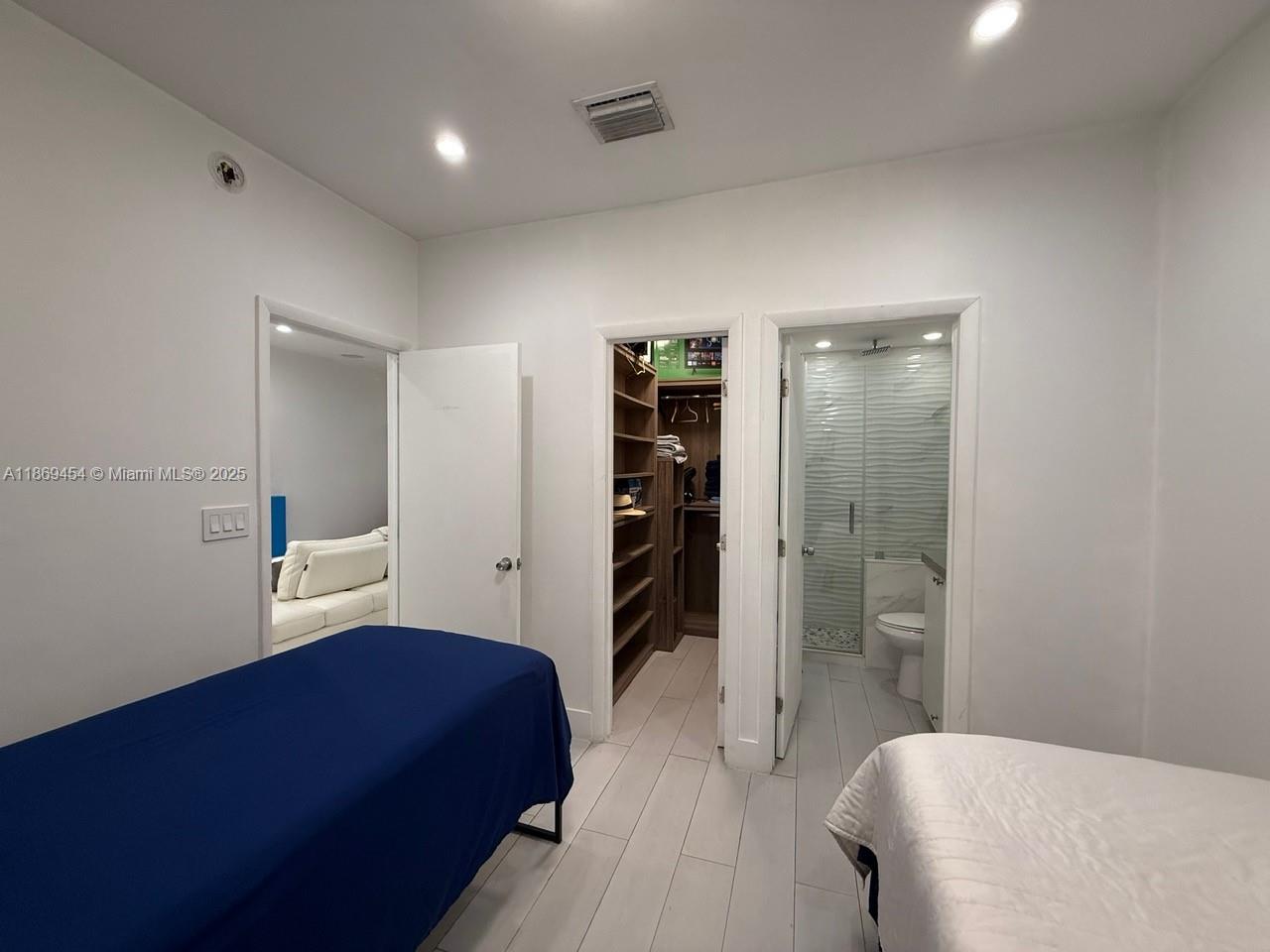 247 Northwest 58th Street Miami, FL 33127 - Photo 17 of 23 a bedroom with a bed and a walk in closet