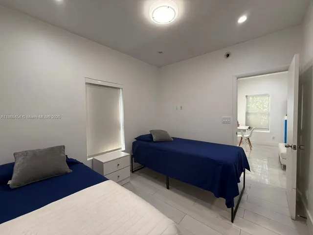 a bedroom with a bed and a mirror