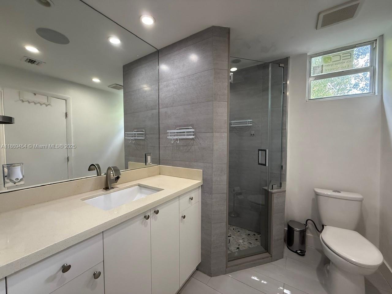 247 Northwest 58th Street Miami, FL 33127 - Photo 19 of 23 a bathroom with a sink toilet and shower