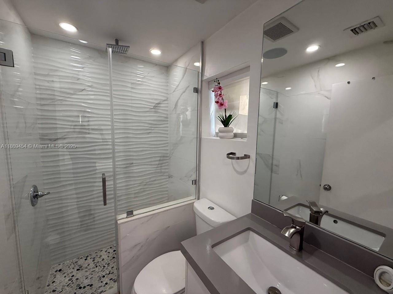 247 Northwest 58th Street Miami, FL 33127 - Photo 20 of 23 a bathroom with a sink a toilet and shower